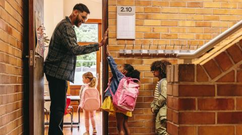 Teacher welcoming students