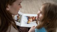 adult and child looking at photo album