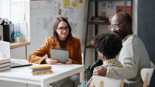 Teacher meeting with parent and child