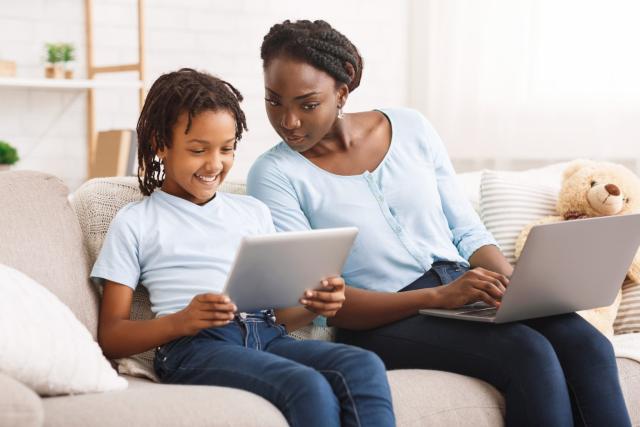 Mother checking child's online safety on screen